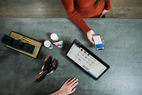 Op de foto zie je iemand die betaalt met een smartphone (contactloos), bij een worldline apparaat. Hier verkopen wij de worldline pinrollen van.